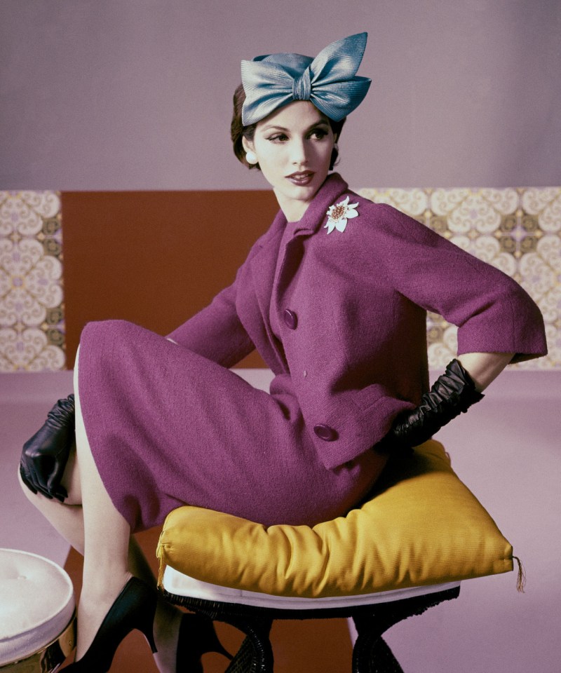 a-model-wears-a-fuchsia-dress-suit-and-hat-with-bow-detail-by-emme-1961