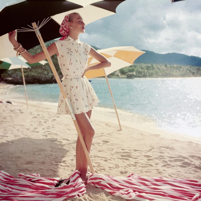 model-standing-under-beach-umbrella-wearing-a-summer-dress-1954